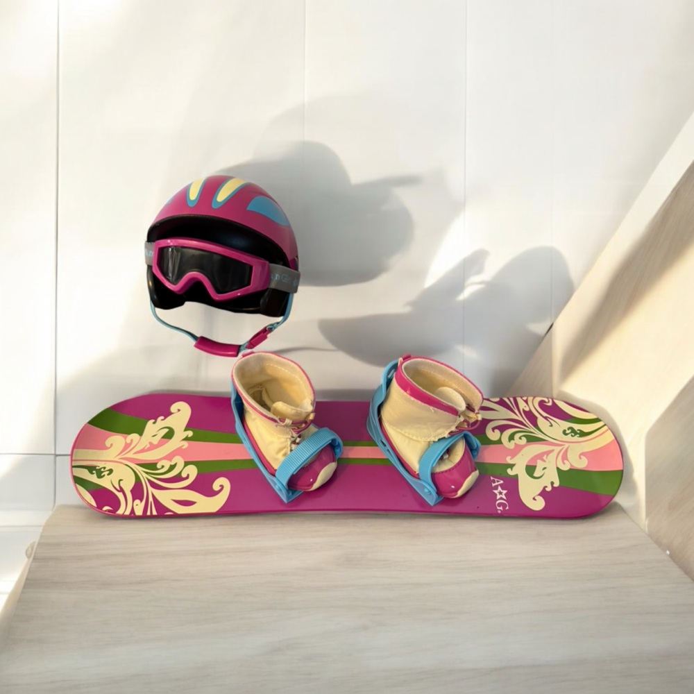 American Girl - Snowboard with attached bindings, boots, helmet and goggles.